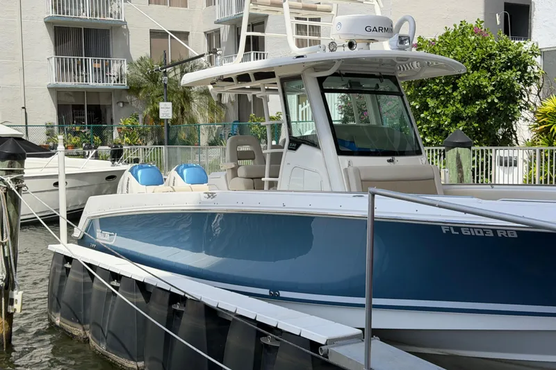 Slide: The Image of 2016 Boston Whaler 330 Outrage boat docked, featuring sleek design and modern equipment. - 29