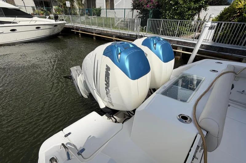 Slide: The Image of 2016 Boston Whaler 330 Outrage with twin Mercury outboard engines docked by a canal. - 3