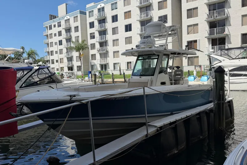 Slide: The Image of 2016 Boston Whaler 330 Outrage docked near waterfront apartments. - 4
