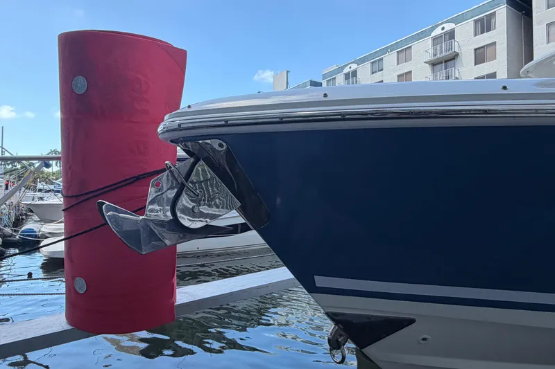Slide: The Image of Boston Whaler 330 Outrage 2016 boat anchored near a red dock bumper. - 5