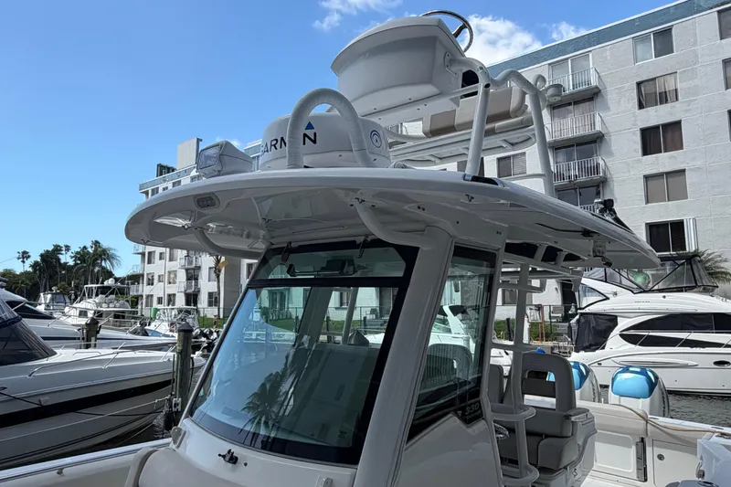 Slide: The Image of 2016 Boston Whaler 330 Outrage boat docked near waterfront buildings. - 7