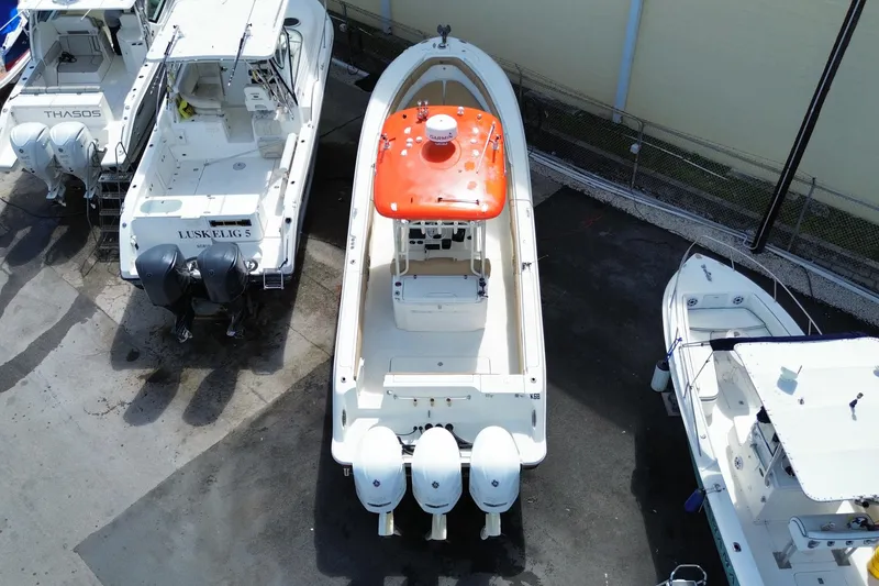 Slide: The Image of 2006 Hydra-Sports Vector 3300 CC boat with triple engines, docked among other vessels. - 10