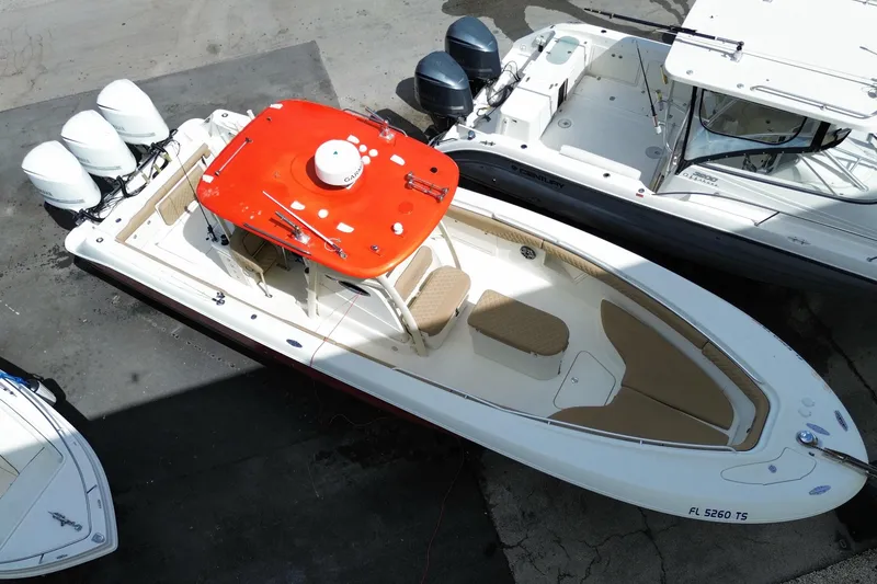 Slide: The Image of 2006 Hydra-Sports Vector 3300 CC boat with red canopy and triple outboard engines. - 11