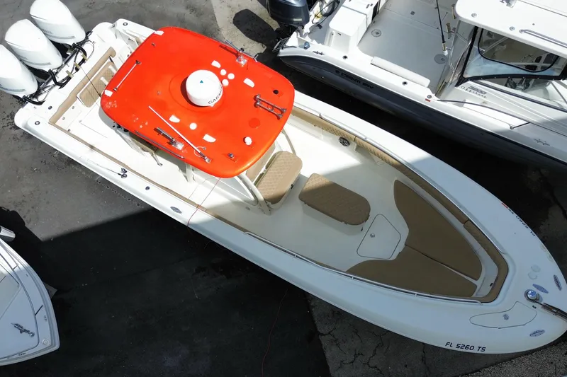 Slide: The Image of 2006 Hydra-Sports Vector 3300 CC boat with red canopy, docked alongside other vessels. - 12