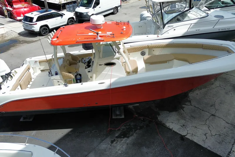 Slide: The Image of 2006 Hydra-Sports Vector 3300 CC boat with orange canopy, docked in a marina. - 13