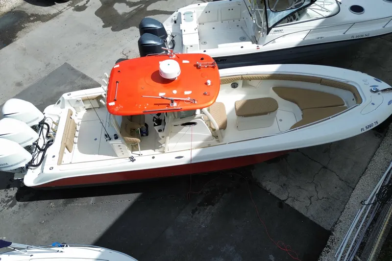 Slide: The Image of 2006 Hydra-Sports Vector 3300 CC boat with red canopy and triple engines, docked. - 14