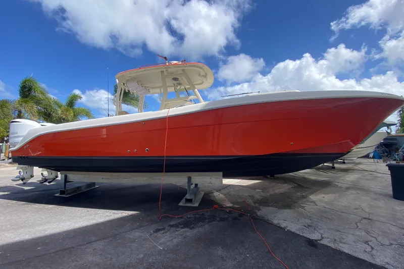 Slide: The Image of 2006 Hydra-Sports Vector 3300 CC boat with red hull, docked under a blue sky. - 15