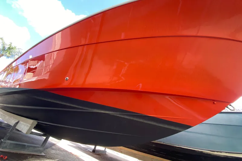 Slide: The Image of 2006 Hydra-Sports Vector 3300 CC boat with vibrant orange and black hull. - 16