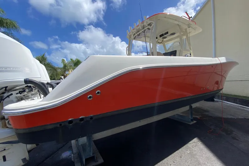 Slide: The Image of 2006 Hydra-Sports Vector 3300 CC boat with red hull, docked under a blue sky. - 18
