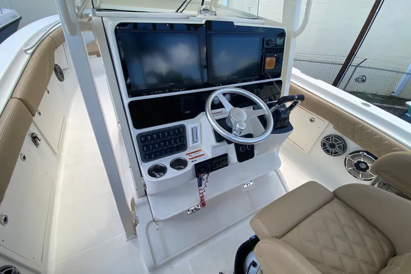 Slide: The Image of 2006 Hydra-Sports Vector 3300 CC boat cockpit with steering wheel and navigation screens. - 28