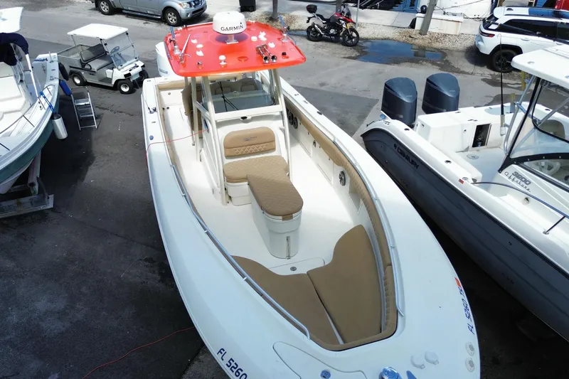 Slide: The Image of 2006 Hydra-Sports Vector 3300 CC boat with red canopy, docked in marina. - 3