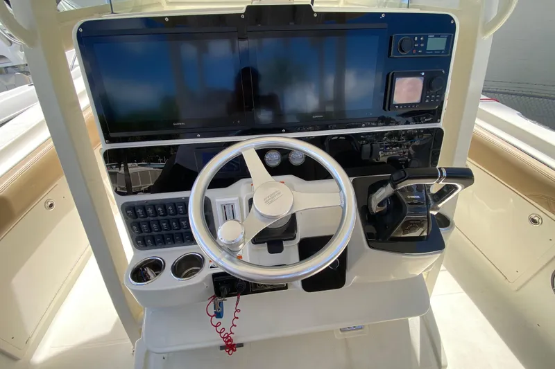 Slide: The Image of 2006 Hydra-Sports Vector 3300 CC helm with steering wheel, controls, and navigation screens. - 30