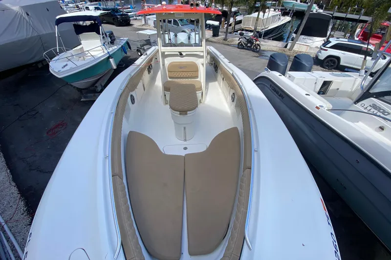 Slide: The Image of 2006 Hydra-Sports Vector 3300 CC boat with spacious seating, docked at a marina. - 37
