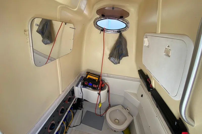 Slide: The Image of 2006 Hydra-Sports Vector 3300 CC cabin interior with toilet and equipment storage. - 38