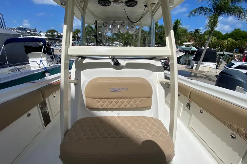 Slide: The Image of 2006 Hydra-Sports Vector 3300 CC boat interior with tan seating and console, docked at marina. - 41
