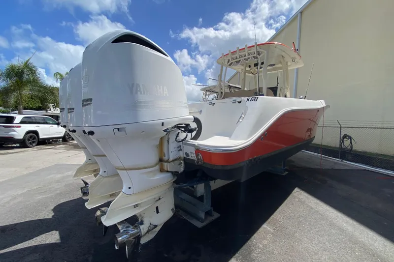 Slide: The Image of 2006 Hydra-Sports Vector 3300 CC boat with twin Yamaha outboard engines, parked outdoors. - 48