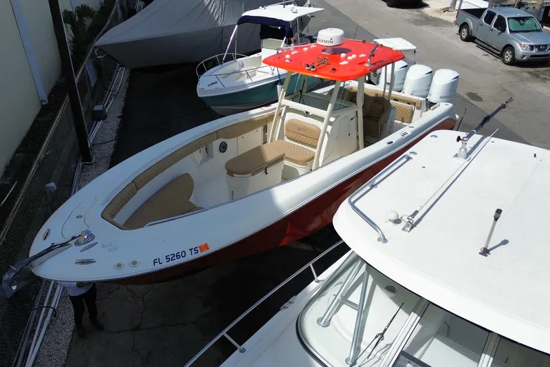 Slide: The Image of 2006 Hydra-Sports Vector 3300 CC boat with red canopy, docked among other vessels. - 5