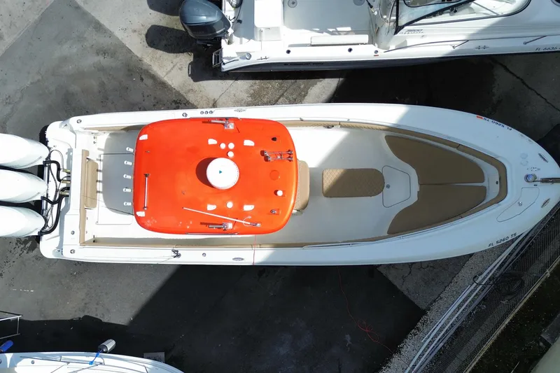 Slide: The Image of Overhead view of a 2006 Hydra-Sports Vector 3300 CC boat docked, featuring a vibrant orange console. - 57