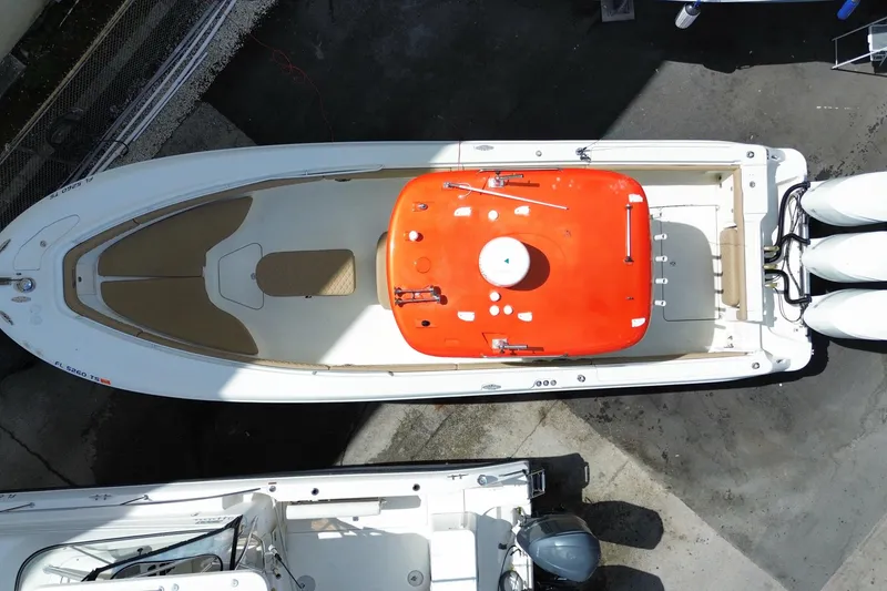Slide: The Image of Overhead view of a 2006 Hydra-Sports Vector 3300 CC boat docked, featuring triple engines. - 58