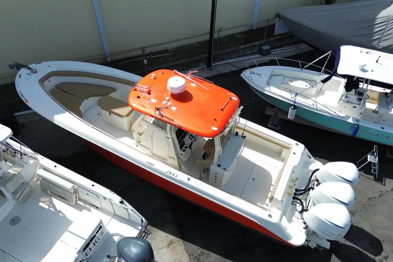 Slide: The Image of 2006 Hydra-Sports Vector 3300 CC boat with red canopy and triple outboard engines. - 6