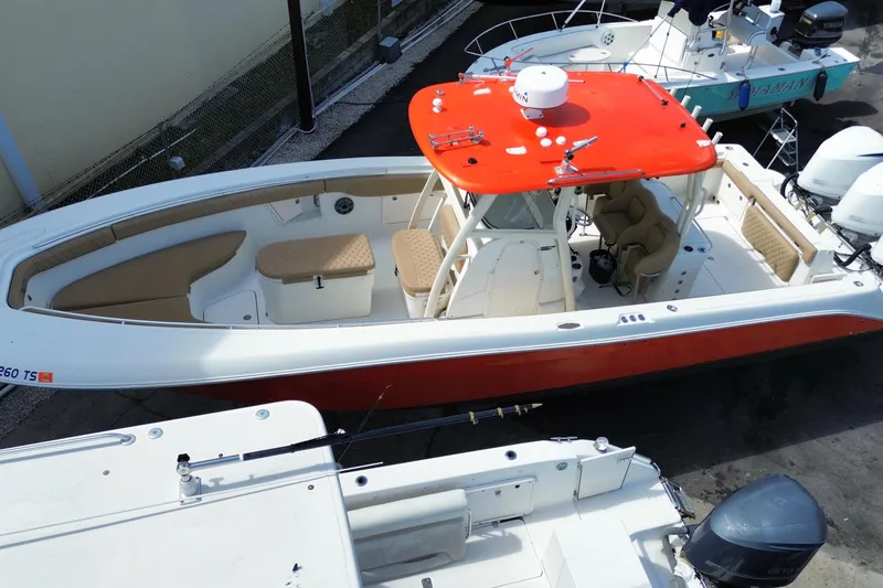 Slide: The Image of 2006 Hydra-Sports Vector 3300 CC boat with red canopy and beige seating, docked. - 7