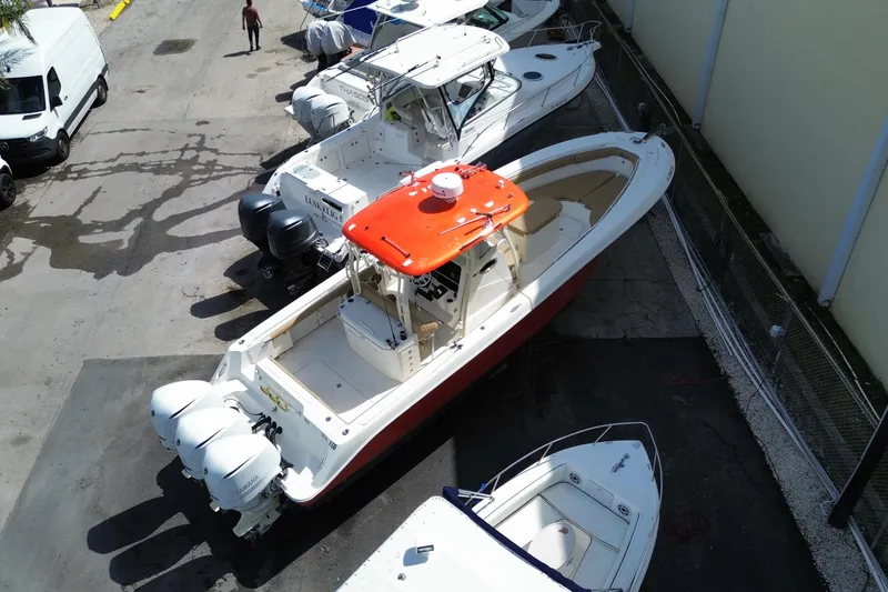Slide: The Image of 2006 Hydra-Sports Vector 3300 CC boat with triple engines, docked in a marina. - 9