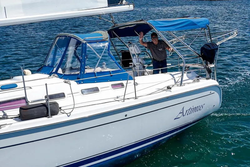 Slide: The Image of Sailboat "Artimus" on water, Hunter 38 model, 2007, with person waving on deck. - 10