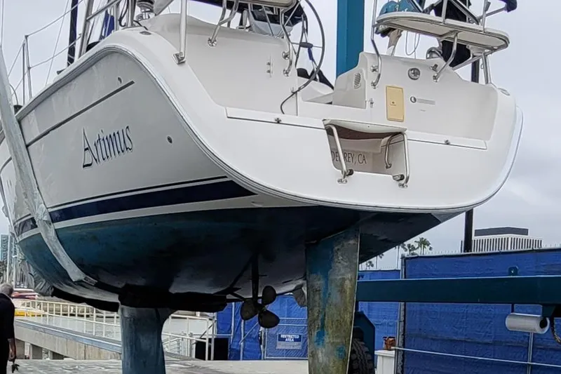 Slide: The Image of Hunter 38 sailboat from 2007 on a lift, displaying its hull and stern. - 15