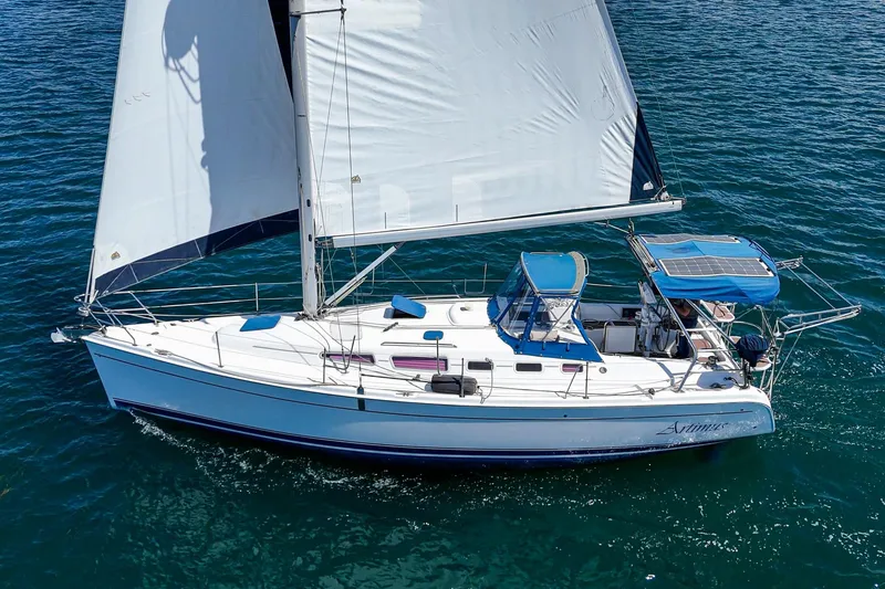 Slide: The Image of Sailing yacht Hunter 38, 2007 model, cruising on open water with full sails. - 2