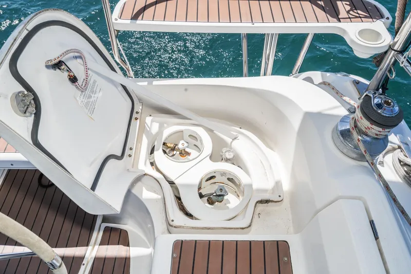 Slide: The Image of 2007 Hunter 38 sailboat deck with open hatch and winch, showcasing nautical equipment. - 23