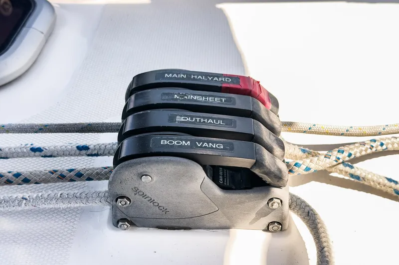 Slide: The Image of Sailboat control lines labeled for main halyard, mainsheet, outhaul, and boom vang on a 2007 Hunter 38. - 25