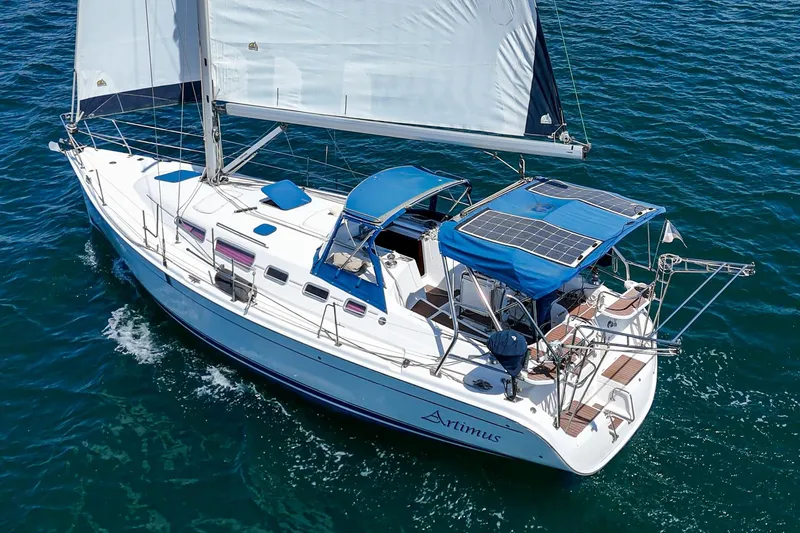 Slide: The Image of Sailing yacht "Artimus," 2007 Hunter 38 model, cruising on open water with solar panels. - 3