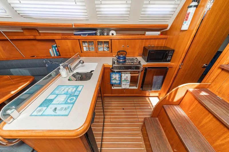 Slide: The Image of Interior of 2007 Hunter 38 sailboat kitchen with wooden cabinetry and modern appliances. - 32