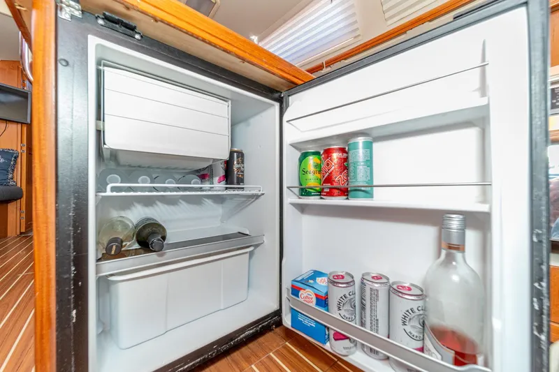 Slide: The Image of Open refrigerator on a 2007 Hunter 38 yacht, stocked with beverages and wine bottles. - 35