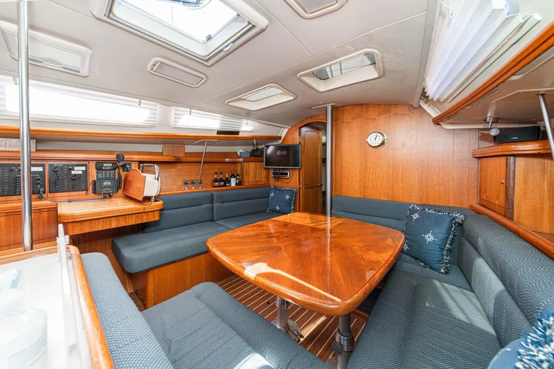 Slide: The Image of Luxurious interior of a 2007 Hunter 38 sailboat with wood finishes and plush seating. - 36