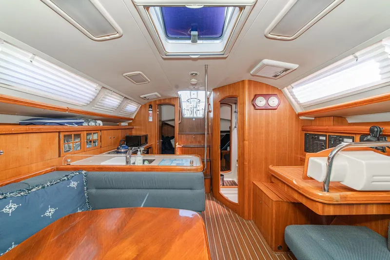 Slide: The Image of Interior of a 2007 Hunter 38 sailboat with wood finish and seating area. - 38