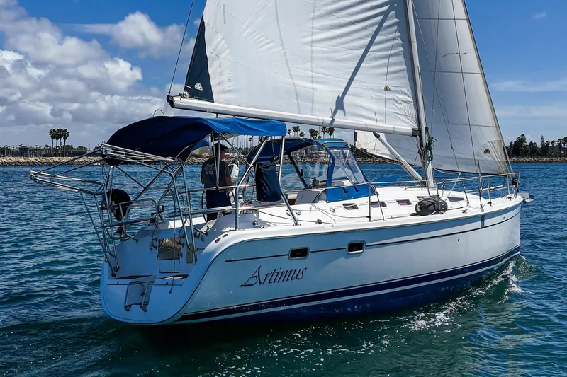 Slide: The Image of Sailing yacht "Artimus," a 2007 Hunter 38, cruising on clear blue waters. - 4