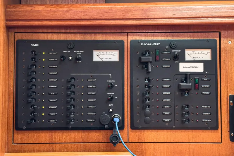 Slide: The Image of Electrical control panel on a 2007 Hunter 38 yacht, featuring 12VDC and 120V-60 Hertz systems. - 40