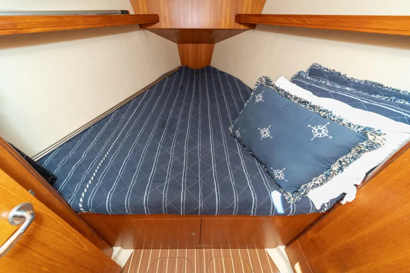 Slide: The Image of Cozy cabin interior of 2007 Hunter 38 sailboat with nautical-themed bedding. - 44