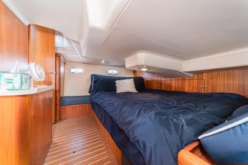 Slide: The Image of Luxurious cabin interior of 2007 Hunter 38 yacht with cozy bedding and wooden finish. - 47