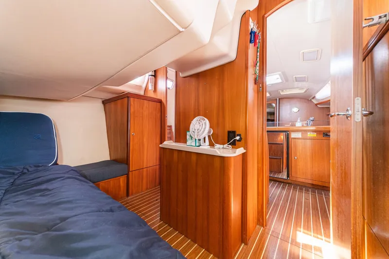 Slide: The Image of Interior of 2007 Hunter 38 sailboat with wooden cabinetry and cozy sleeping area. - 48