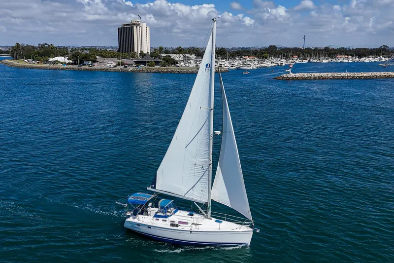 Slide: The Image of Sailboat Hunter 38 (2007) cruising in a scenic harbor with clear skies. - 5