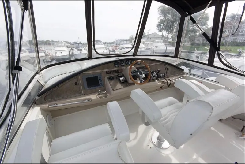 Slide: The Image of 2005 Carver 360 Sport Sedan helm with white seats and navigation controls. - 1