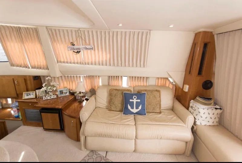 Slide: The Image of Interior of 2005 Carver 360 Sport Sedan with elegant leather seating and wooden table. - 12