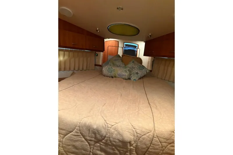 Slide: The Image of 2005 Carver 360 Sport Sedan bathroom with shower, sink, and wooden floor mat. - 16