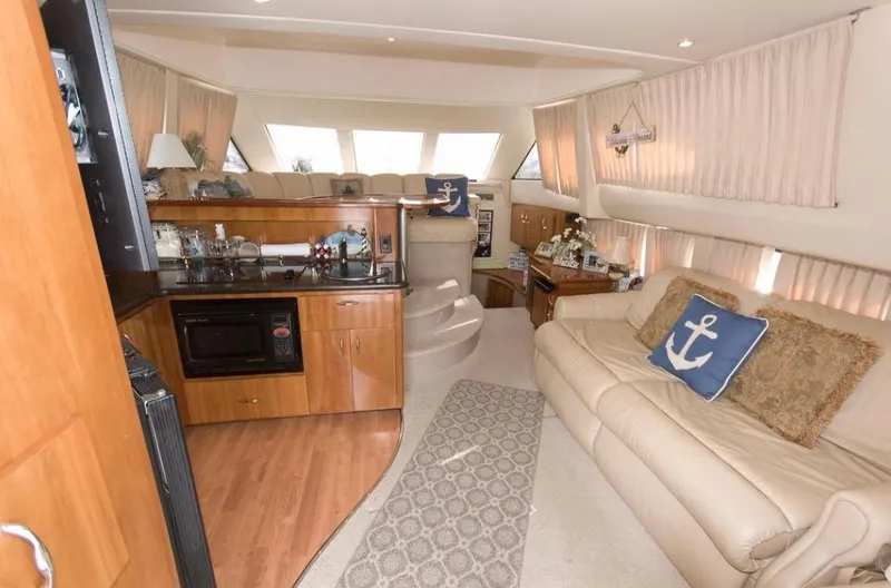 Slide: The Image of Interior of 2005 Carver 360 Sport Sedan with cozy seating and nautical decor. - 2
