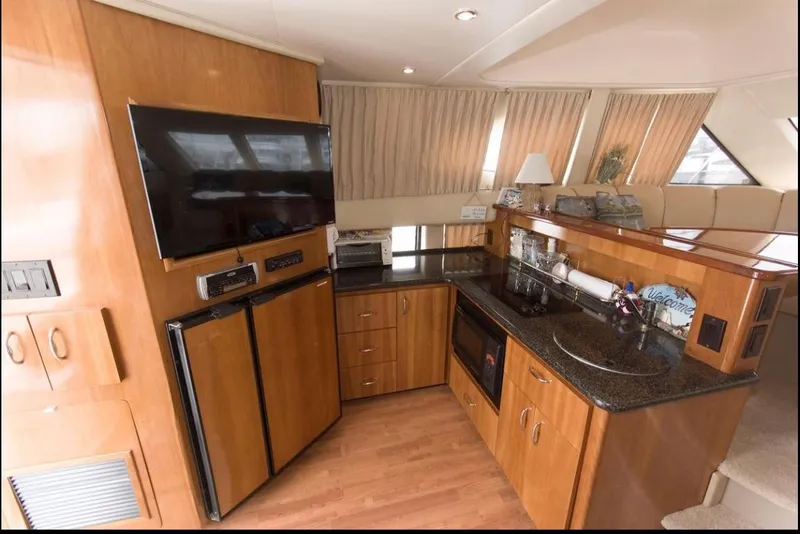 Slide: The Image of Interior of 2005 Carver 360 Sport Sedan with modern kitchen and entertainment area. - 3