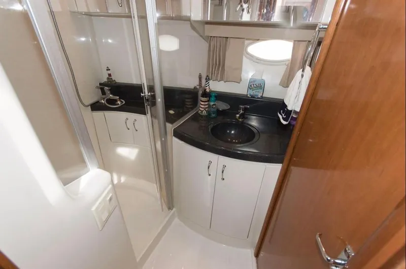 Slide: The Image of 2005 Carver 360 Sport Sedan bathroom with sink, shower, and storage cabinets. - 8