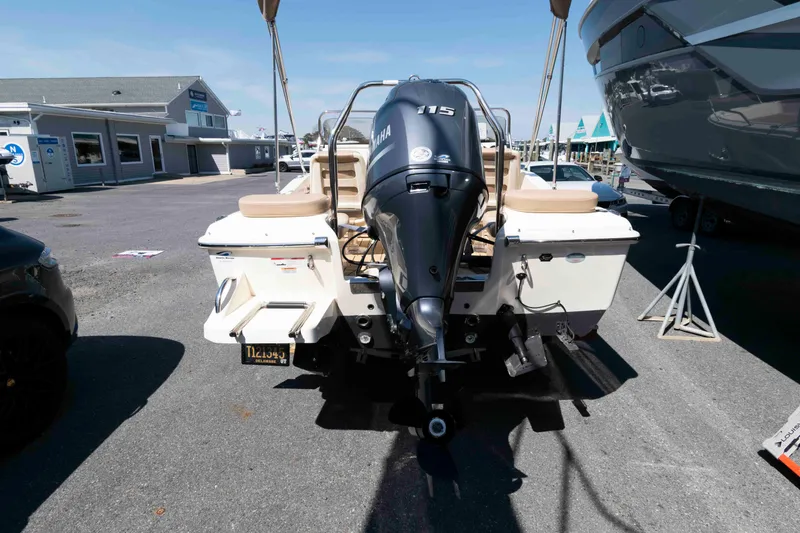 Slide: The Image of 2023 Scout 175 Sportfish boat with Yamaha 115 engine, parked outdoors. - 3