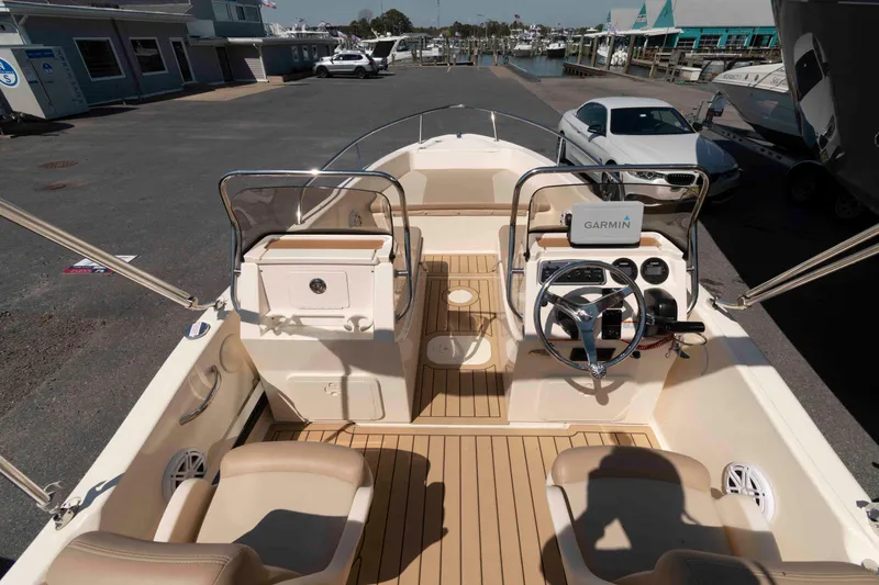 Slide: The Image of 2023 Scout 175 Sportfish boat interior with Garmin navigation, docked at marina. - 5